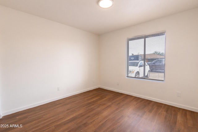 empty room featuring dark hardwood / wood-style flooring