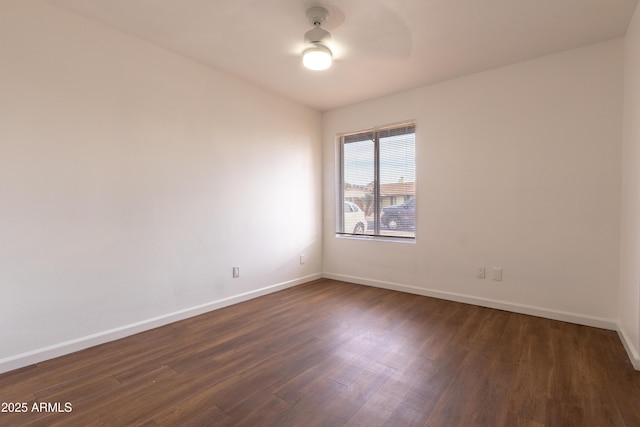 unfurnished room with dark wood-type flooring and ceiling fan