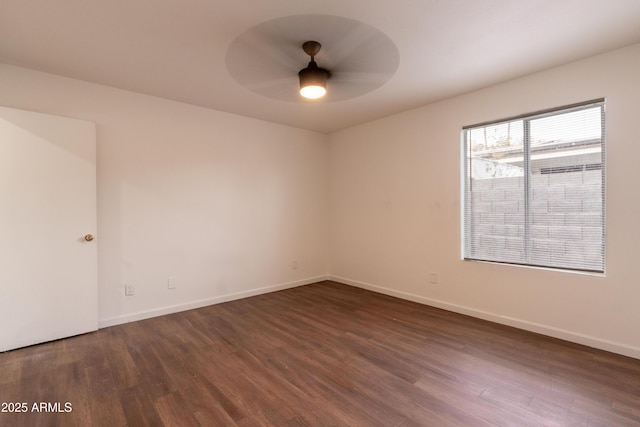 unfurnished room featuring dark hardwood / wood-style floors and ceiling fan