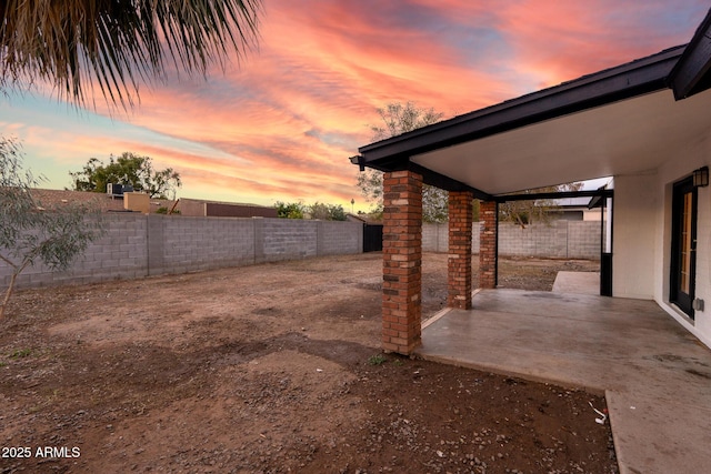 yard at dusk with a patio area