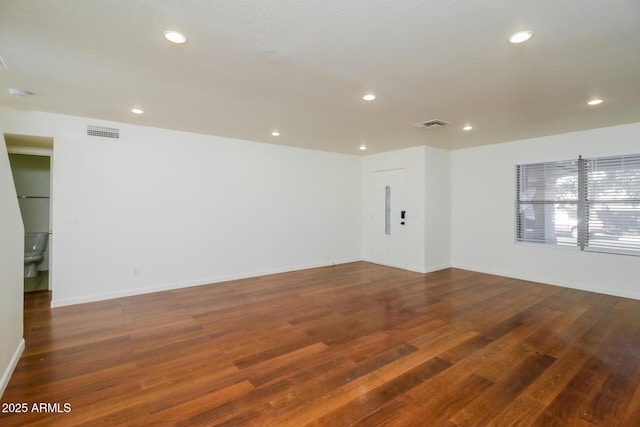 unfurnished room featuring dark hardwood / wood-style floors