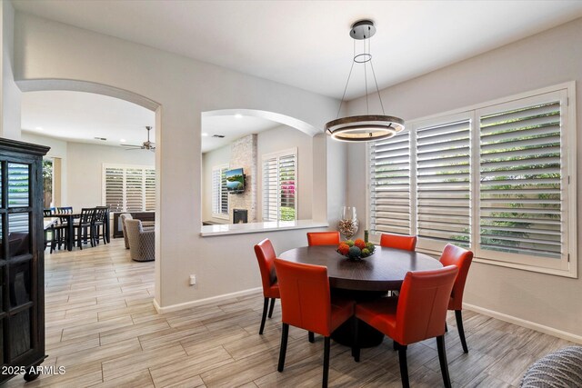 7979 E Princess Dr Unit 13, Scottsdale, AZ 85255 - living area featuring arched walkways, light wood finished floors, and recessed lighting