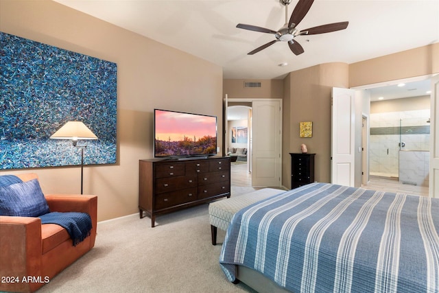 carpeted bedroom featuring ceiling fan and ensuite bathroom