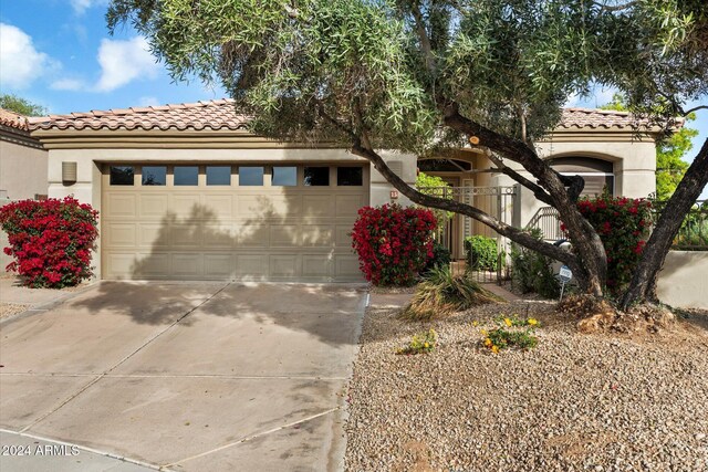 7979 E Princess Dr Unit 13, Scottsdale, AZ 85255 - mediterranean / spanish home with driveway, a tiled roof, stucco siding, and a garage