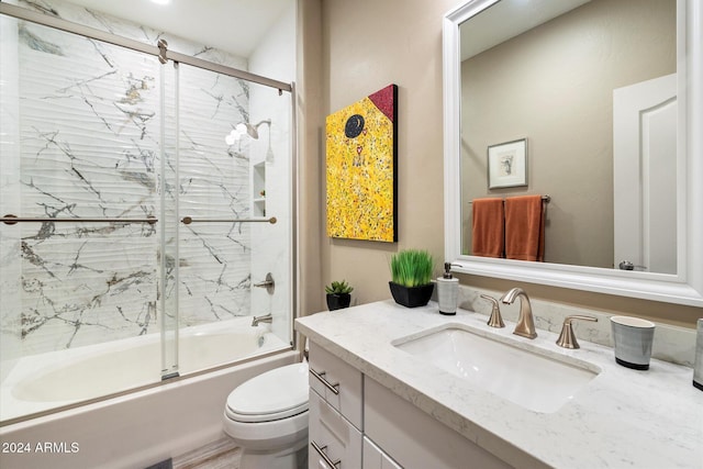 full bathroom with vanity, toilet, and shower / bath combination with glass door