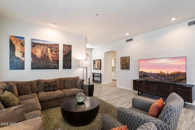 7979 E Princess Dr Unit 13, Scottsdale, AZ 85255 - indoor dry bar featuring wine cooler, wood finished floors, a stone fireplace, arched walkways, and recessed lighting