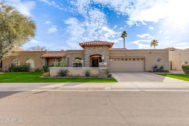 mediterranean / spanish-style house featuring a garage and a front yard