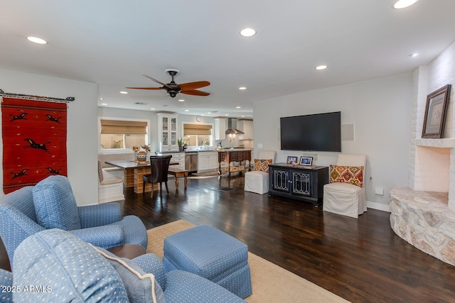 living room with ceiling fan and dark hardwood / wood-style flooring