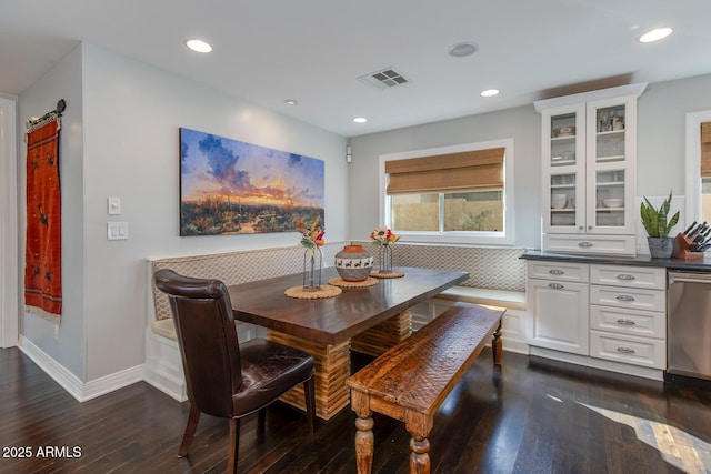 dining space with dark hardwood / wood-style flooring