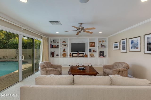 carpeted living room with crown molding, built in features, and ceiling fan