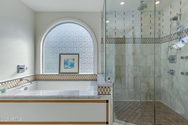 bathroom featuring shower with separate bathtub