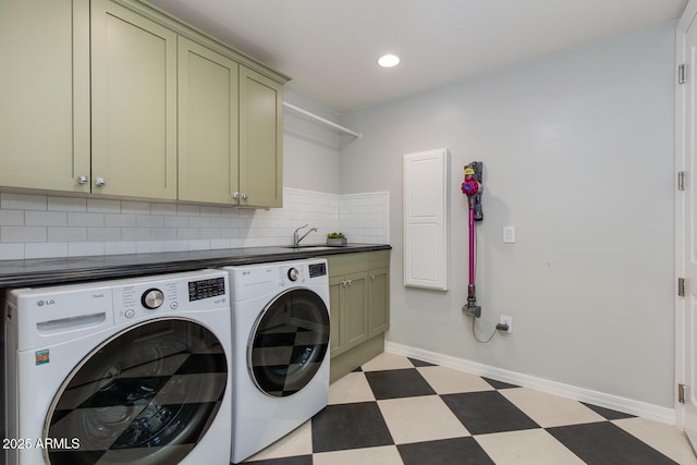 laundry area with sink, washer and clothes dryer, and cabinets