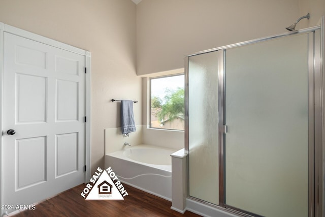 bathroom with hardwood / wood-style floors and plus walk in shower