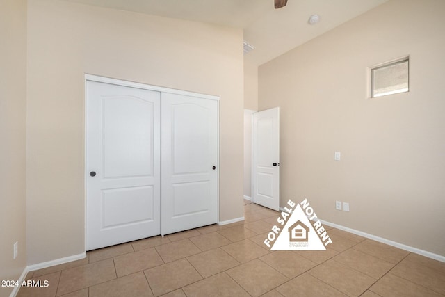 unfurnished bedroom with light tile patterned floors and a closet