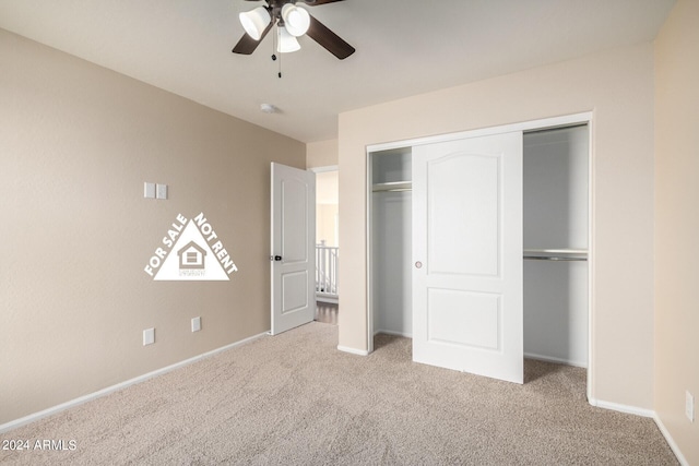 unfurnished bedroom with light carpet, a closet, and ceiling fan