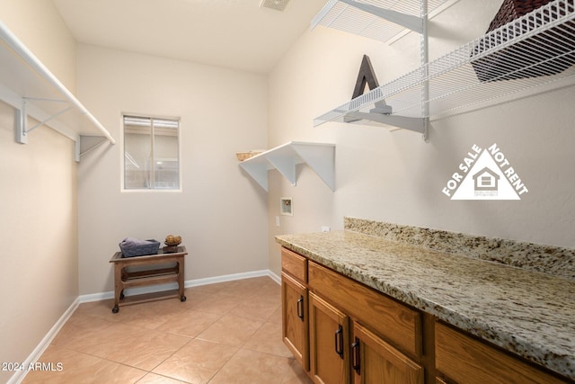 laundry room with hookup for a washing machine and light tile patterned flooring