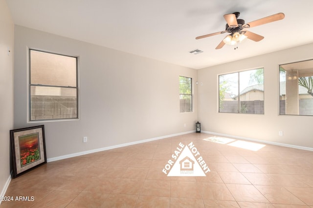 unfurnished room featuring ceiling fan and light tile patterned floors