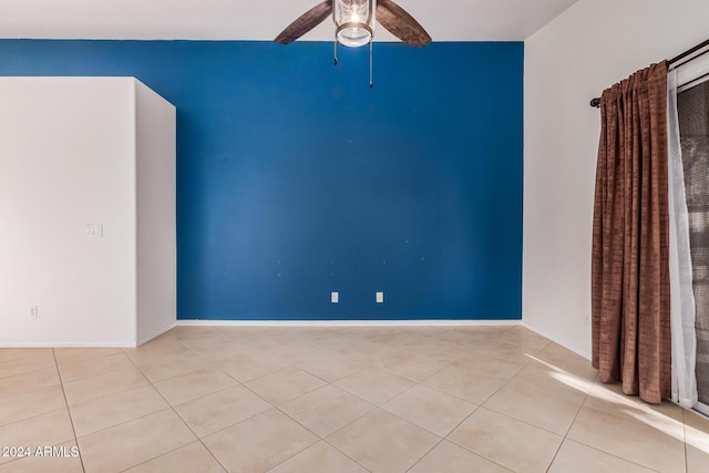 tiled empty room with ceiling fan