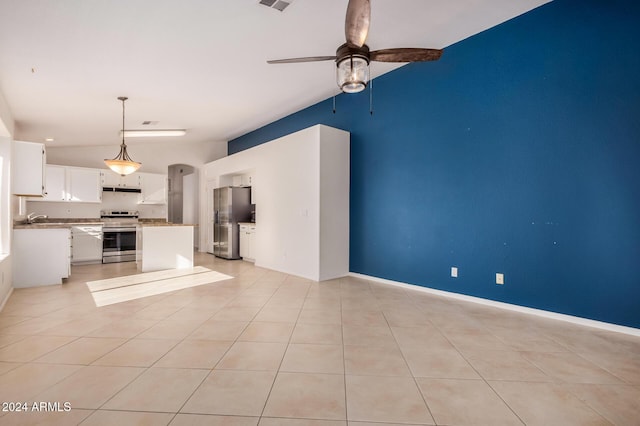 unfurnished living room featuring ceiling fan, light tile patterned floors, and sink