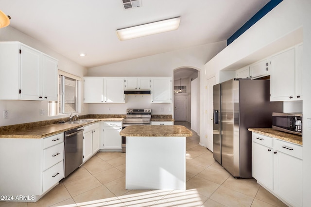 kitchen featuring white cabinetry, sink, lofted ceiling, a kitchen island, and appliances with stainless steel finishes