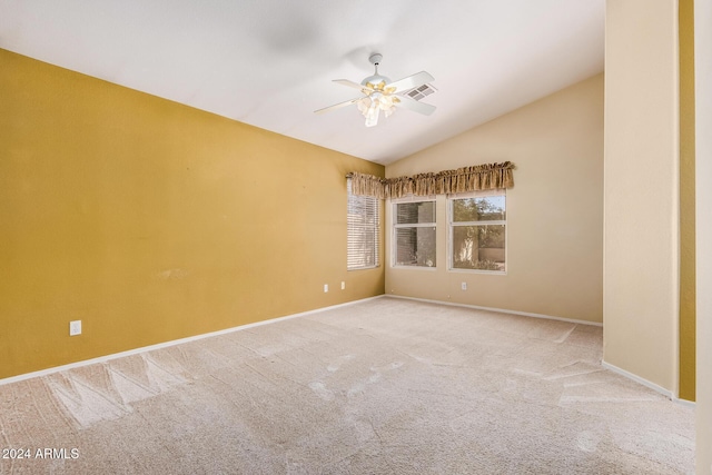 carpeted spare room featuring ceiling fan and lofted ceiling