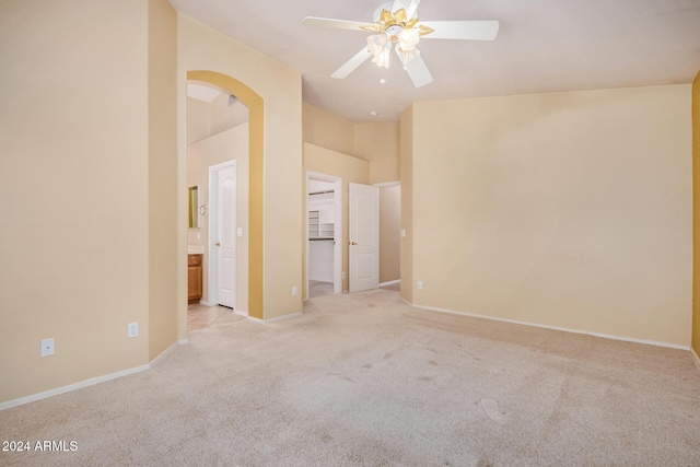 carpeted spare room with ceiling fan