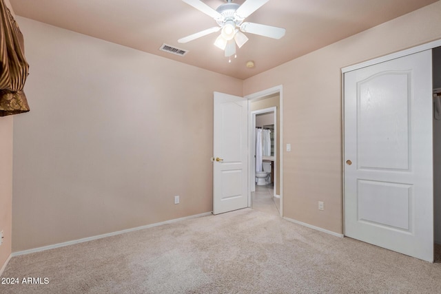 unfurnished bedroom featuring ceiling fan and light carpet