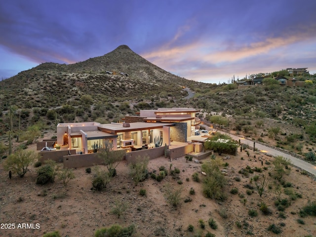 39602 N Charles Blair Macdonald Rd, Scottsdale, AZ 85262 - back of house at dusk featuring a mountain view and stucco siding