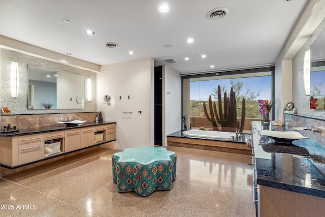 39602 N Charles Blair Macdonald Rd, Scottsdale, AZ 85262 - full bath featuring vanity, a bath, backsplash, recessed lighting, and speckled floor