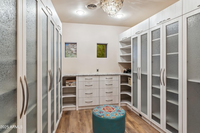 39602 N Charles Blair Macdonald Rd, Scottsdale, AZ 85262 - spacious closet with wood finished floors and a chandelier