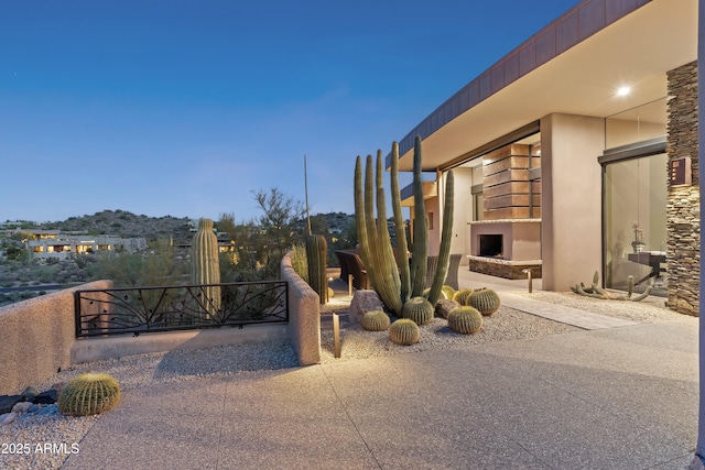 39602 N Charles Blair Macdonald Rd, Scottsdale, AZ 85262 - exterior space with stucco siding and a fireplace