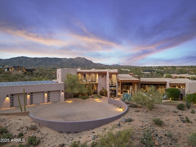 39602 N Charles Blair Macdonald Rd, Scottsdale, AZ 85262 - pueblo revival-style home with a mountain view, stucco siding, an attached garage, and driveway