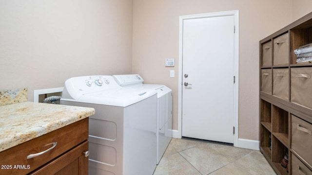 clothes washing area featuring light tile patterned floors and washing machine and clothes dryer