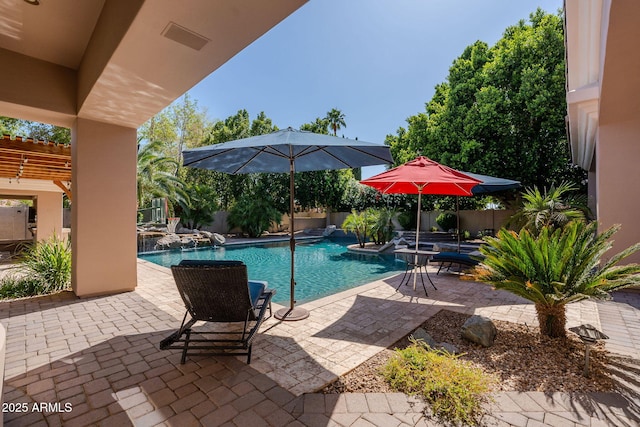 pool featuring a jacuzzi, a patio, and a fenced backyard