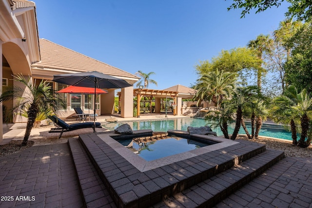 pool featuring a patio area, an in ground hot tub, and a pergola