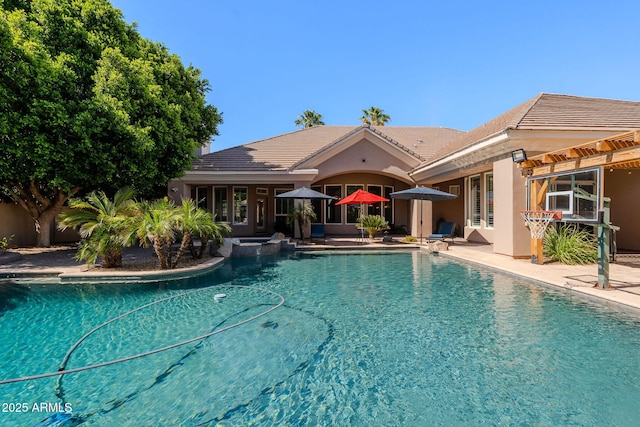 view of pool with a patio and a pool with connected hot tub
