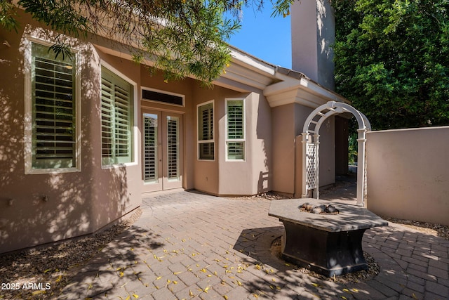 view of patio / terrace with an outdoor fire pit and french doors