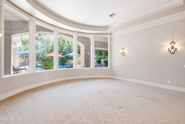 spare room with carpet flooring, visible vents, baseboards, and a healthy amount of sunlight