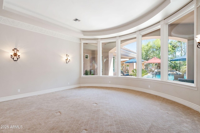 carpeted empty room with visible vents and baseboards