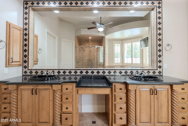 bathroom featuring a stall shower, tasteful backsplash, ceiling fan, and a sink