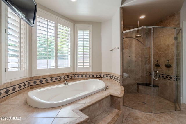 bathroom featuring a stall shower, tile patterned floors, a garden tub, and recessed lighting