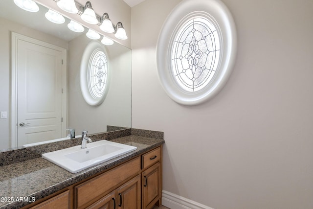 bathroom featuring baseboards and vanity