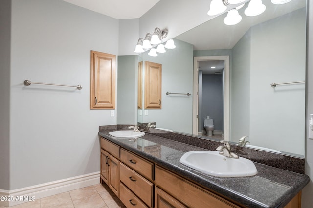 bathroom with a sink, double vanity, toilet, and tile patterned flooring