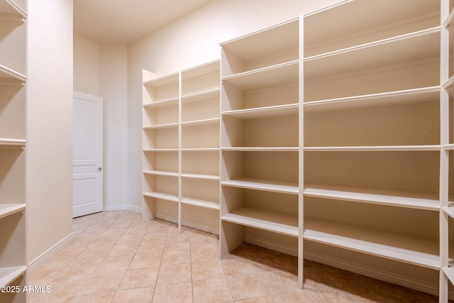 spacious closet with tile patterned flooring