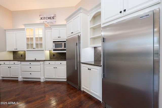 kitchen with built in appliances, white cabinetry, open shelves, backsplash, and dark wood-style floors