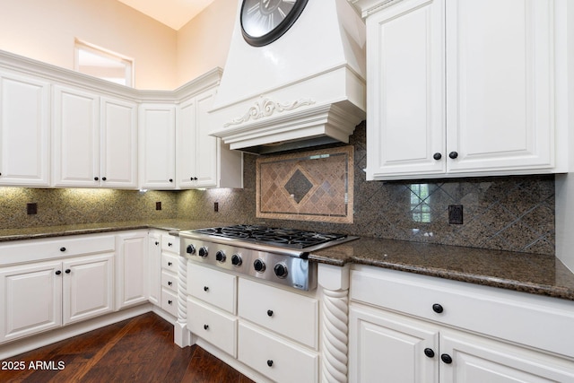 kitchen with white cabinetry, dark wood-style flooring, custom range hood, and stainless steel gas cooktop