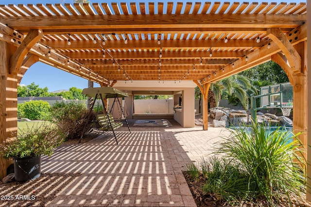 view of patio / terrace with a pergola and fence