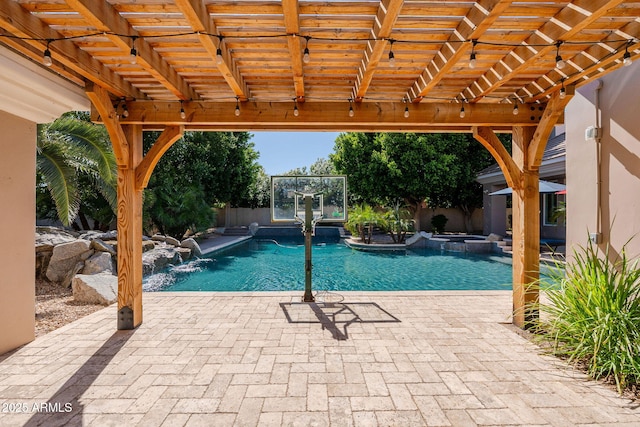 view of swimming pool with a pool with connected hot tub, a patio, and a fenced backyard
