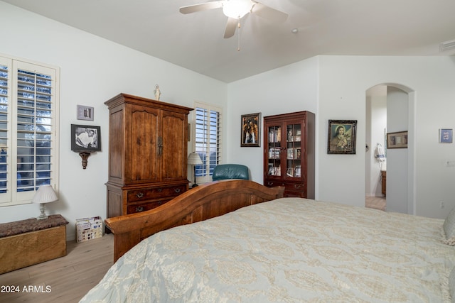 bedroom featuring ceiling fan, light hardwood / wood-style flooring, and vaulted ceiling