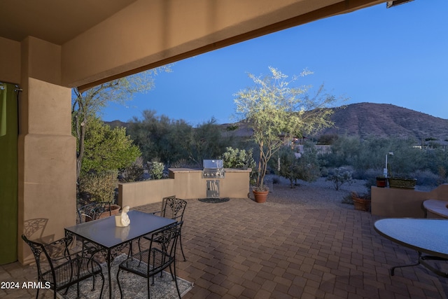 view of patio / terrace with area for grilling and a mountain view